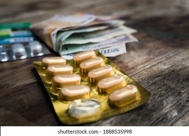 A Table Top Shot Of Medicines With Money And Credit Cards. A Large Amount Of People's Income Goes To Their Medical Bills