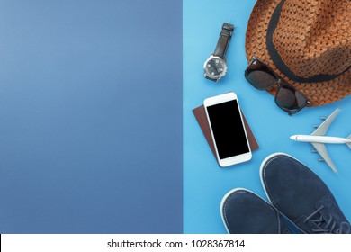 Table top view accessory of clothing women  plan to travel in holiday background concept.Mobile phone with many essential  items hat & shoes on modern rustic duo blue paper with space creative design. - Powered by Shutterstock