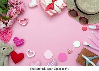 Table top view accessory of clothing women to plan travel in valentine's day background concept.cosmetic & clothes with many essential love items in holiday season.Several objects on pink paper.