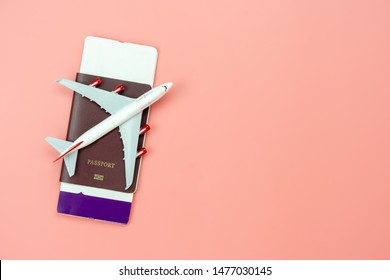 Table top view accessory of accessory travel in holiday background concept.Flat lay of airplane with passport and boarding pass ticket on modern rustic pink paper at home studio office desk.copy space - Powered by Shutterstock