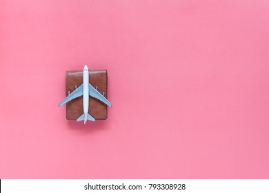 Table top view accessory of accessory travel in holiday background concept.Flat lay of airplane with leather wallet on modern rustic pink paper at home studio office desk.copy space for creative. - Powered by Shutterstock