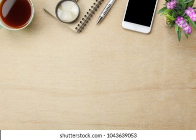 Table Top View Aerial Image Stationary On Office Desk Background Concept.Flat Lay Objects The Cup Of Black Coffee With Essential Accessory & Tree Plant.Items On Modern Brown Wooden At Home Studio.