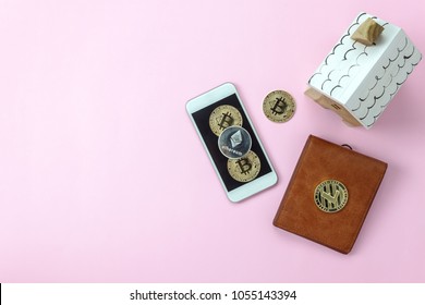 Table Top View Aerial Image Of Cryptocurrency Or Digital Money Background Concept.Flat Lay Bitcoins & Mobile Phone And Other Object Wallet & House On Modern Pink Paper At Home Office Desk.Space Design