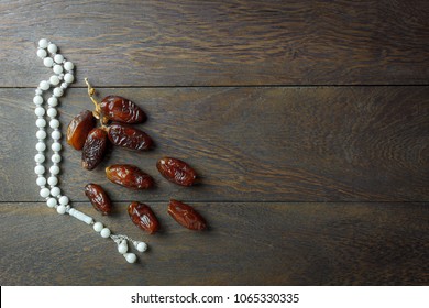 Table Top View Aerial Image Of Decoration Ramadan Kareem Holiday Background.Flat Lay Accessory Date With White Rosary On Modern Rustic Brown Wood At Office Desk.space For Creative Design Add Text.