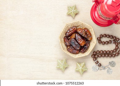 Table Top View Aerial Image Of Decoration Ramadan Kareem Holiday Background.Flat Lay Date In Wood Basket With Brown Rosary & Red Lantern.Essential Object Star On Rustic White Wood At Office Desk.