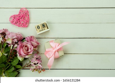 Table Top View Aerial Image Of Decorations For International Women's Day  Holiday Concept Background.Flat Lay Sign Of Season The Word 8 March Happy Woman's Day With Flower And Gift Box On White Wooden