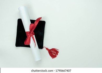 Table Top View Aerial Image Of Graduation Of Education Season Background Concept.Flat Lay Accessories Cap With Certificate Paper On Modern Rustic White Paper.Free Space For Creative Design Mock Up.