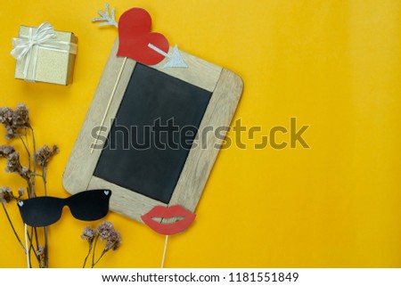 Table top view aerial image of sign anniversary wedding party day background concept.Photo booth props on modern grunge yellow wallpaper at home office desk studio.Space for creative design mock up.