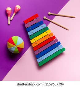 Table Top View Kids Toys For Develop Background Concept.Flat Lay Objects The Colorful Wooden Ball Percussion Musical Instruments On Modern Duo Paper Blue & Pink At Office Desk. Design Pastel Tone.