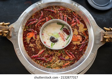 Table Top View Of Mala Seasoning Spicy Chinese Hotpot. Hotpot Is An Interactive Meal In Which Diners Sit Around A Simmering Pot Of Soup At The Center Of The Table With Ingredients.