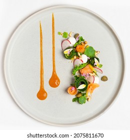 Table top view of minimalist and elegant fine dine smoked salmon salad on grey ceramic plate. Appetiser with courgette, nasturtiums, radish, capers and walnuts. - Shutterstock ID 2075811670
