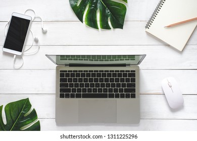 Table Top Working Space Office Desk Laptop - Notebook - Smartphone and Stationary on White Wood Table Background