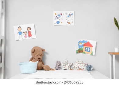 Table with toys and children's drawings on wall in pediatrician's office - Powered by Shutterstock