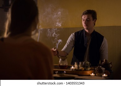 Table with traditional tea setting for chinese tea ceremony. Warm romantic illumination, low key. Relaxation, meditative and chinese culture concept