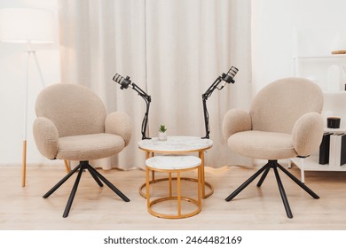 A table and two chairs are prepared for creating a podcast. Cozy atmosphere. - Powered by Shutterstock