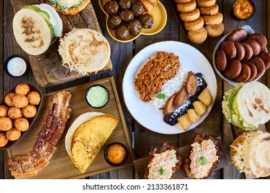 Table With Typical Venezuelan Food. Creole Pavilion, Arepas, Fried Pork And Stuffed Empanadas