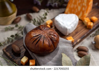 Table With Varieties Of Cheese Brie Camembert Cheddar Parmesan Cheese With Bell Peppers On A Wooden Board Adorned With Dried Flowers Oil And Pepper Shaker