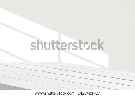 table with window shadow against white wall for product mockup display