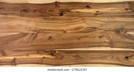 Table Wooden Surface From Natural Walnut. Rich Wood Grain Texture Background With Knots And Strong Lines. Copy Space