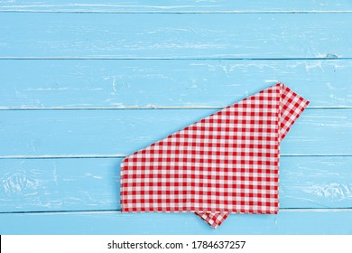 Tablecloth red and white checkerboard pattern on old blue wooden table with copy space for a background. - Shutterstock ID 1784637257