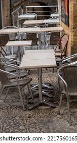 Tables And Chairs In A Cobbled Street For Drinking And Dining Outside