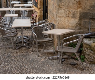 Tables And Chairs In A Cobbled Street For Drinking And Dining Outside