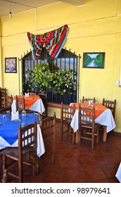 Tables And Chairs Inside An Mexican Restaurant