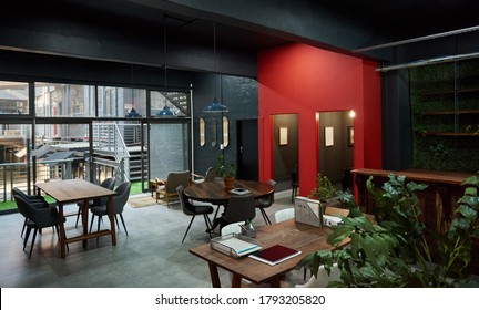 Tables and chairs in the work area of an open plan office space after working hours - Powered by Shutterstock