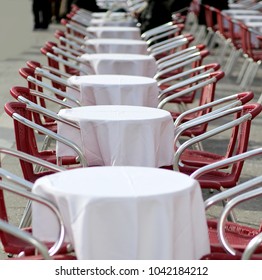 Tables And Red Chairs In An Alfresco Cafe In The European City