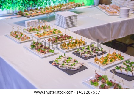 tables in the restaurant with snacks and dishes. easy food for guests. business lunch. preparing for the Banquet. smorgasbord. mass event, coffee break. .Catering event plate service, Self-service