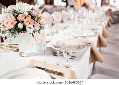 Tables set for an event party or wedding reception. luxury elegant table setting dinner in a restaurant. glasses and dishes.