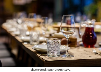 Tables Set For An Event Party Or Wedding Reception. Luxury Elegant Table Setting Dinner In A Restaurant. Glasses And Dishes. Empty Glasses Set In Restaurant. Part Of Interior.