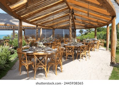 tables setting, garden with palm trees, beach hut, tropical garden, restaurant in the resort, restaurant on the beach - Powered by Shutterstock