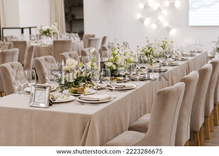 Tables setting at a luxury wedding. Table for guests. Dishes and drinks. Wedding table preparation. 