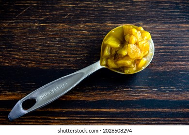 Tablespoon Of Canned Hatch Green Peppers: A Measuring Spoon Filled With Diced Green New Mexico Chili Peppers