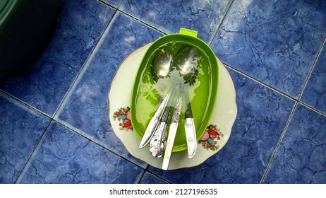 Tablespoon, In A Green Place. And A Blue Background With A Little Water