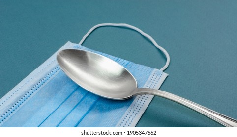 Tablespoon On Medical Mask. The Concept Of The Entrance To The Restaurant And Dining Room In Mask. Masked Food