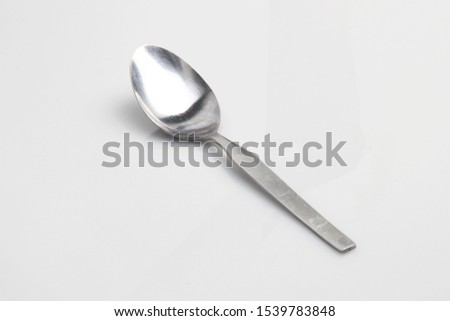 a tablespoon with a white background