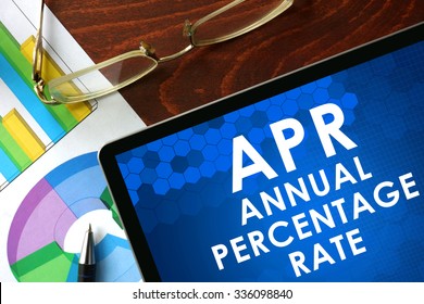 Tablet With Annual Percentage Rate (APR) On A Table. Business Concept.