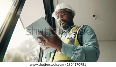 Tablet, black man and construction worker on site with research for building development. Technology, email and mature civil engineer with feedback for renovation, repairs or maintenance from below.