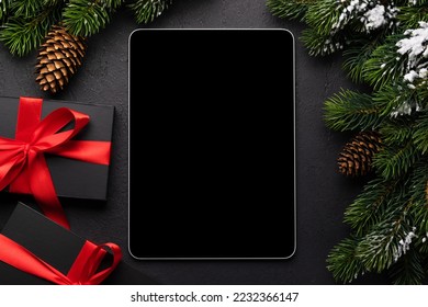 Tablet with blank screen, gift boxes and Christmas decor. Xmas device screen template - Powered by Shutterstock