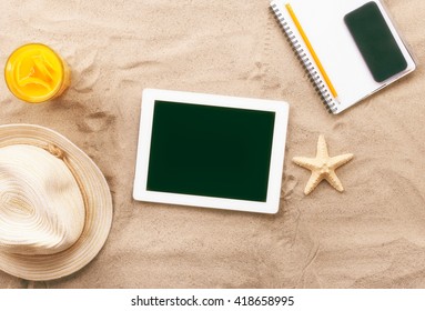 Tablet With Blank Screen On The Sand On The Sea Beach, Top View