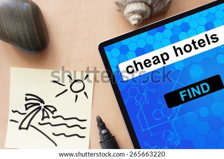 Tablet with cheap hotels. Travel concept.