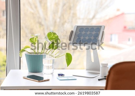 Tablet computer with calendar on doctor's desk in medical office