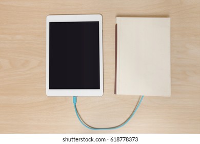 tablet computer connected to the old book with a cable, and download information from there