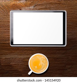 tablet computer and cup of coffee on table, view from above