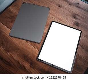 Tablet computer device with blank screen template lying on wooden table in home interior