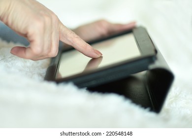 Tablet computer in female hands close up