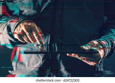 Tablet Computer In Male Hands In Dark Room, Digital Glitch Effect In Post Production, Low Key Close Up