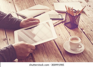 Tablet computer in men hands. concept  man working from home using tablet computer. Free space for text. Closeup. View top. Vintage toned